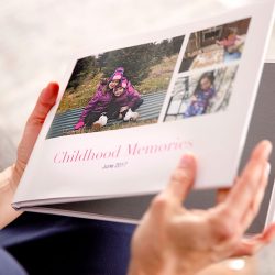 photo essay app for iphone A person holding a custom photo book | Motif