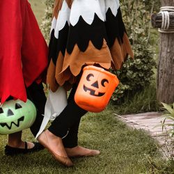 A group of kids with jack-o-lantern buckets for trick-or-treating | Motif