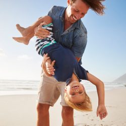 Father and son playing at the beach | Motif.