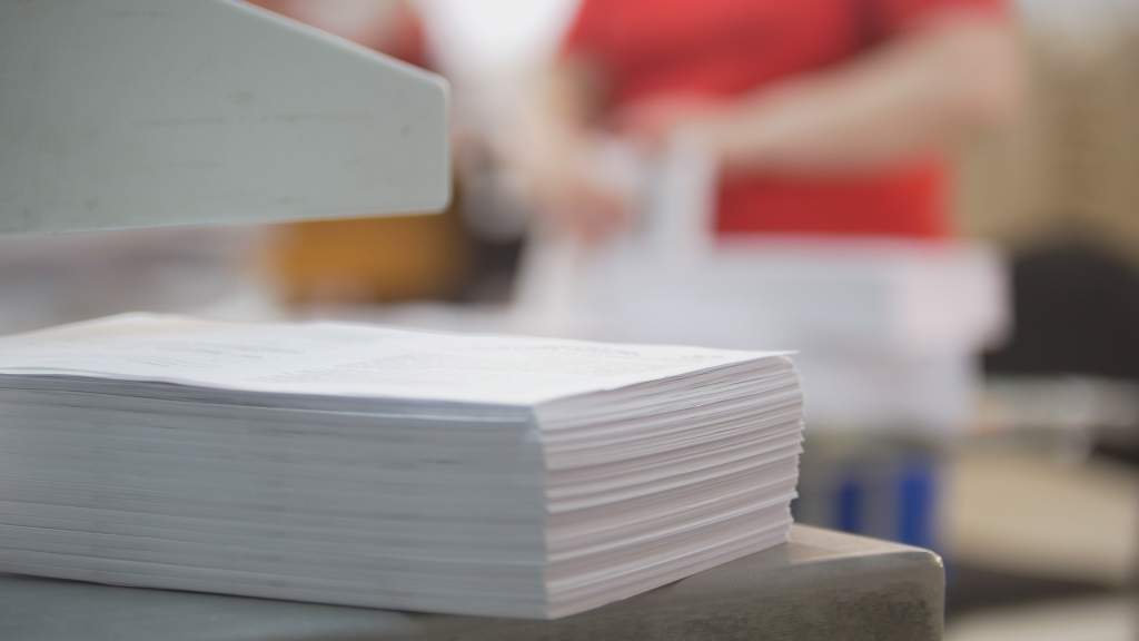 A stack of high-quality paper used to create Apple photo book designs.