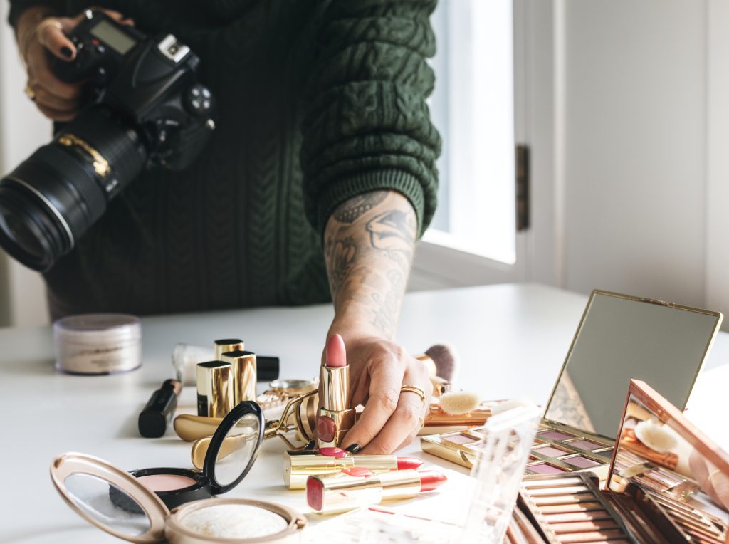 Beauty blogger taking photo of cosmetics