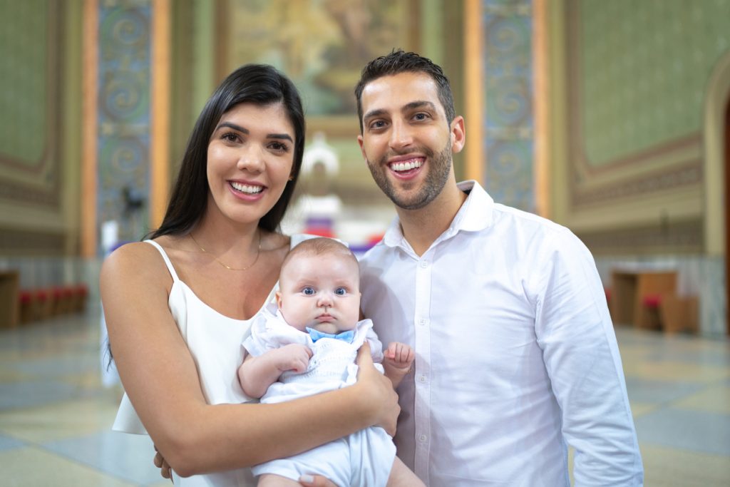 Godparents with a godson baby at baptism celebration